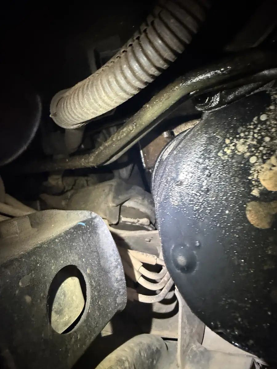 Underbody leak evidence found during a used-car inspection